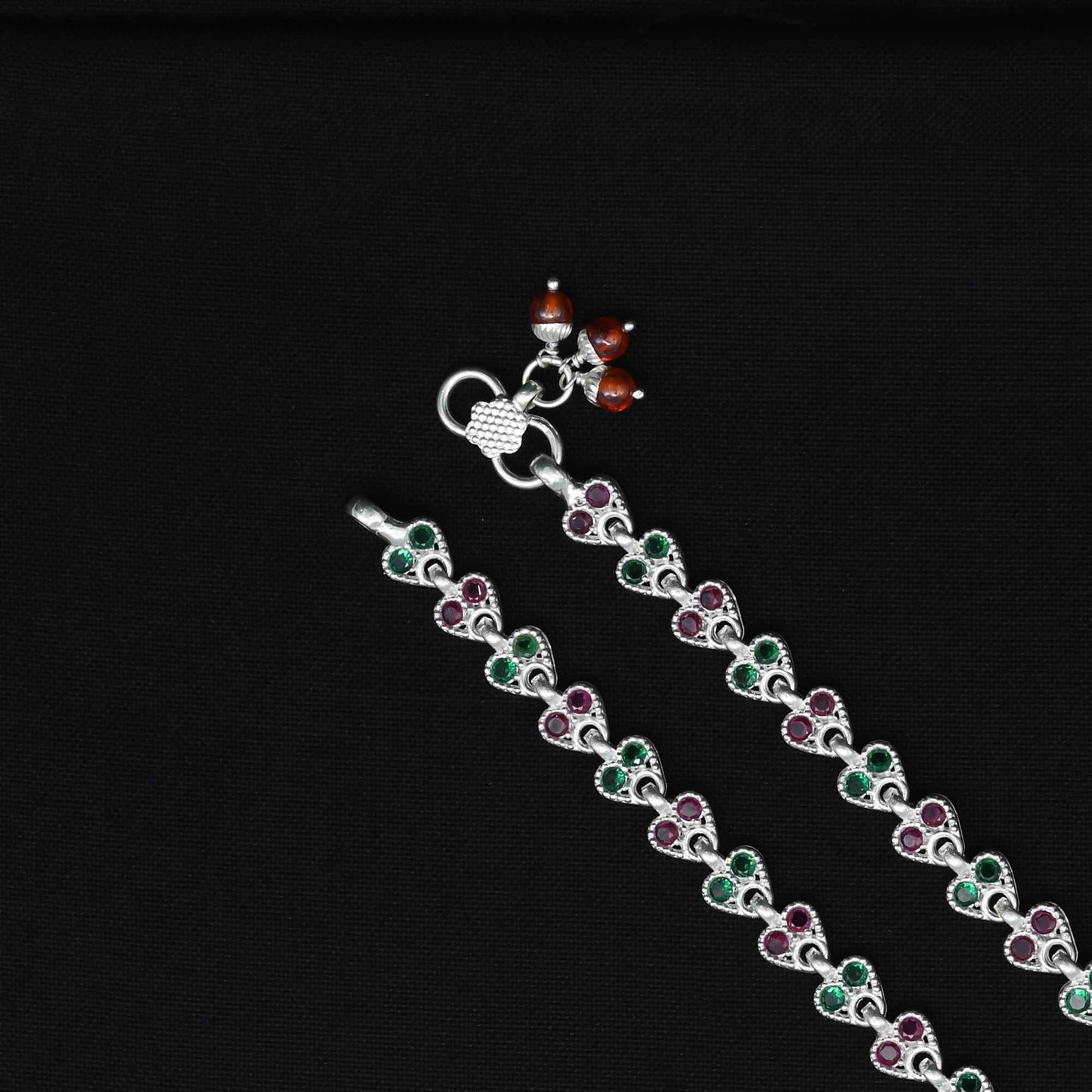 Stunning silver anklet with pink and green gemstones, perfect for adding a glamorous touch