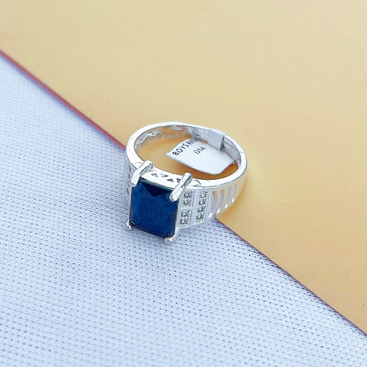 Modern silver ring for men with a striking bold blue stone.
