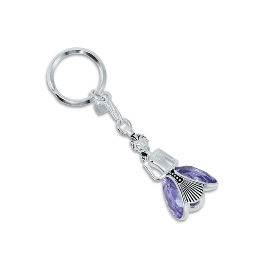 Stylish silver keychain featuring a unique doll design and a striking purple gemstone