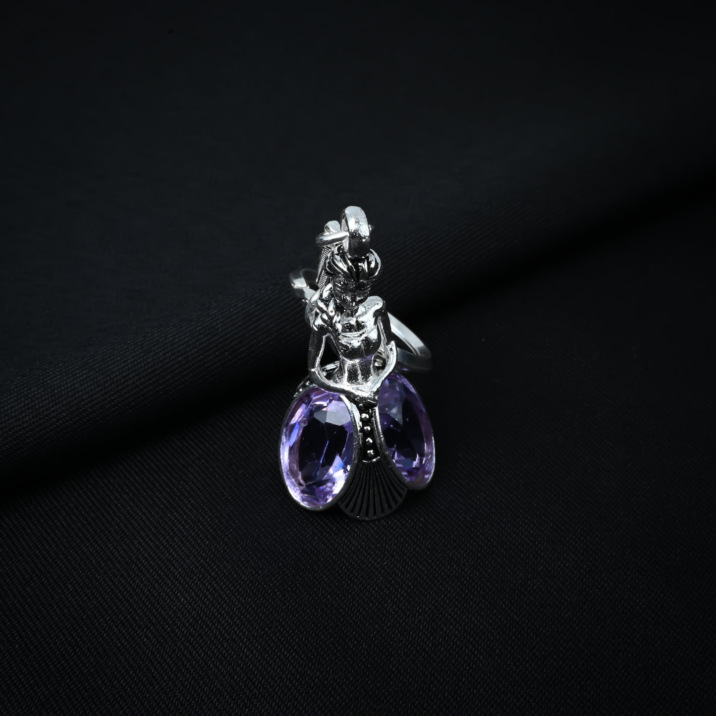 Fashionable silver keychain with a doll motif and purple stone, perfect for a trendy look