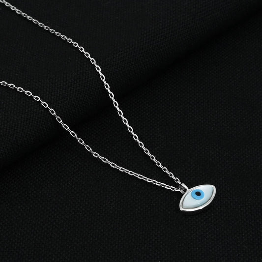 Close-up of the silver chain featuring a detailed evil eye pendant.