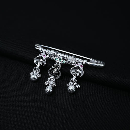 Silver saree pin featuring a bell design with ghungroo and stones