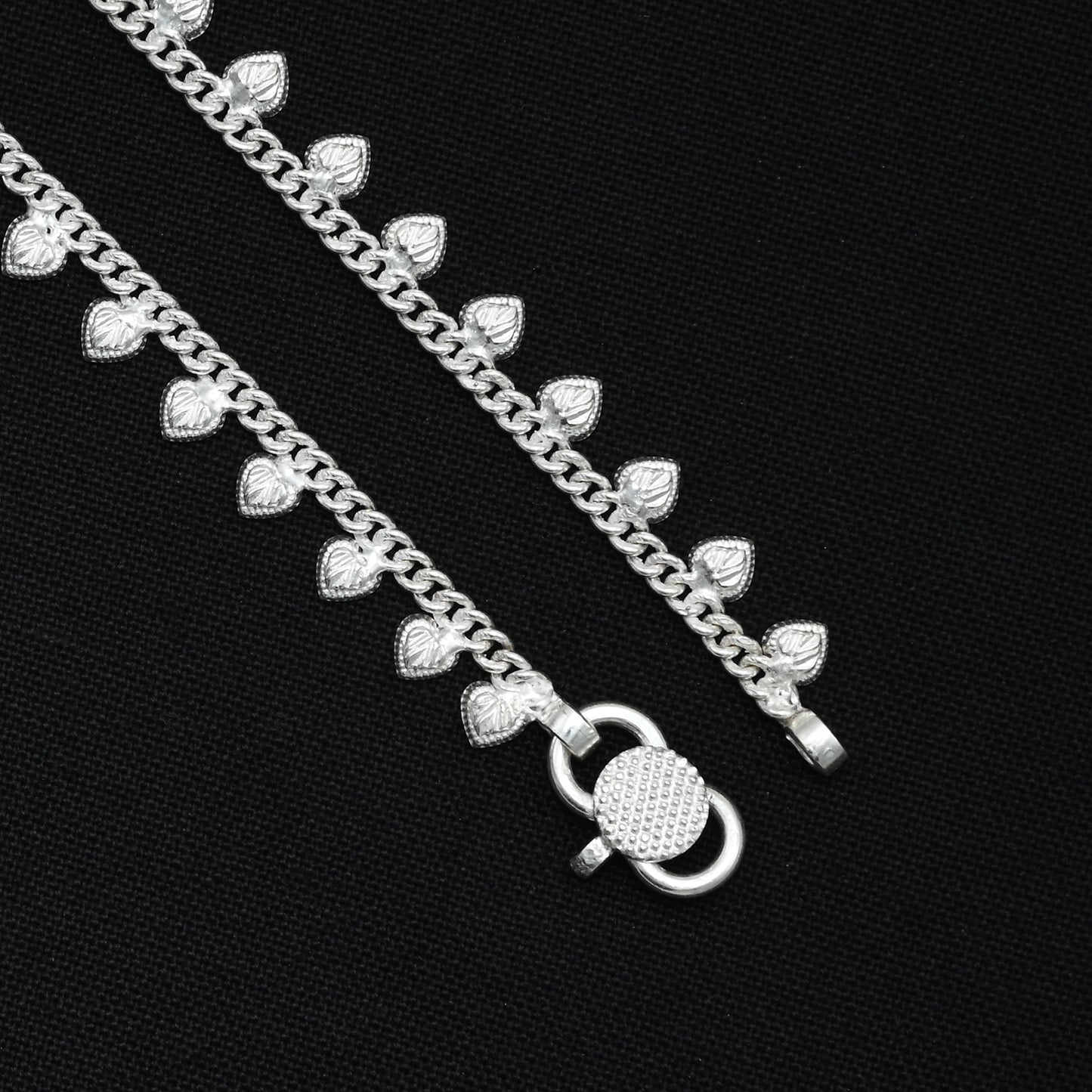Silver anklet with heart-shaped accents, creating a stunning and playful design
