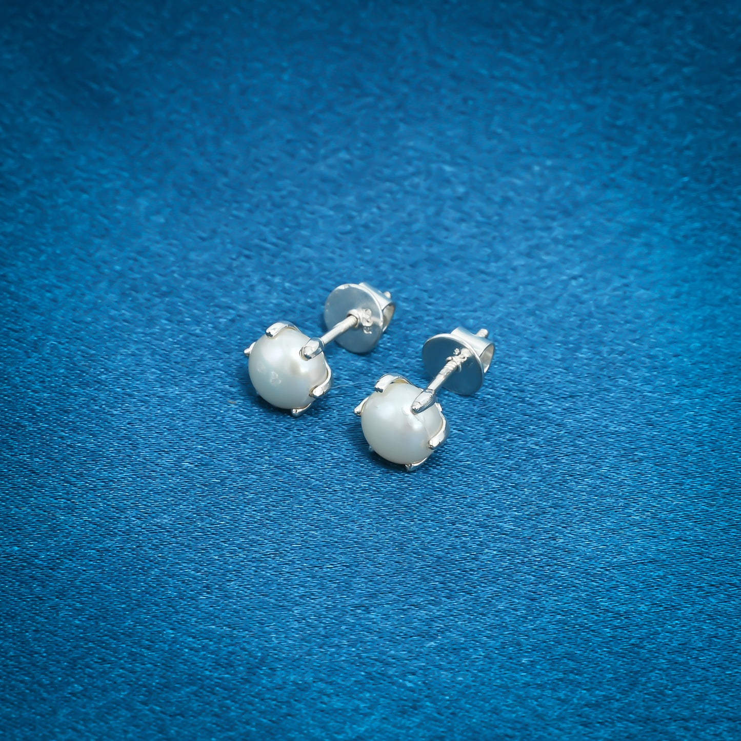 Elegant pearl stud earrings set in sterling silver