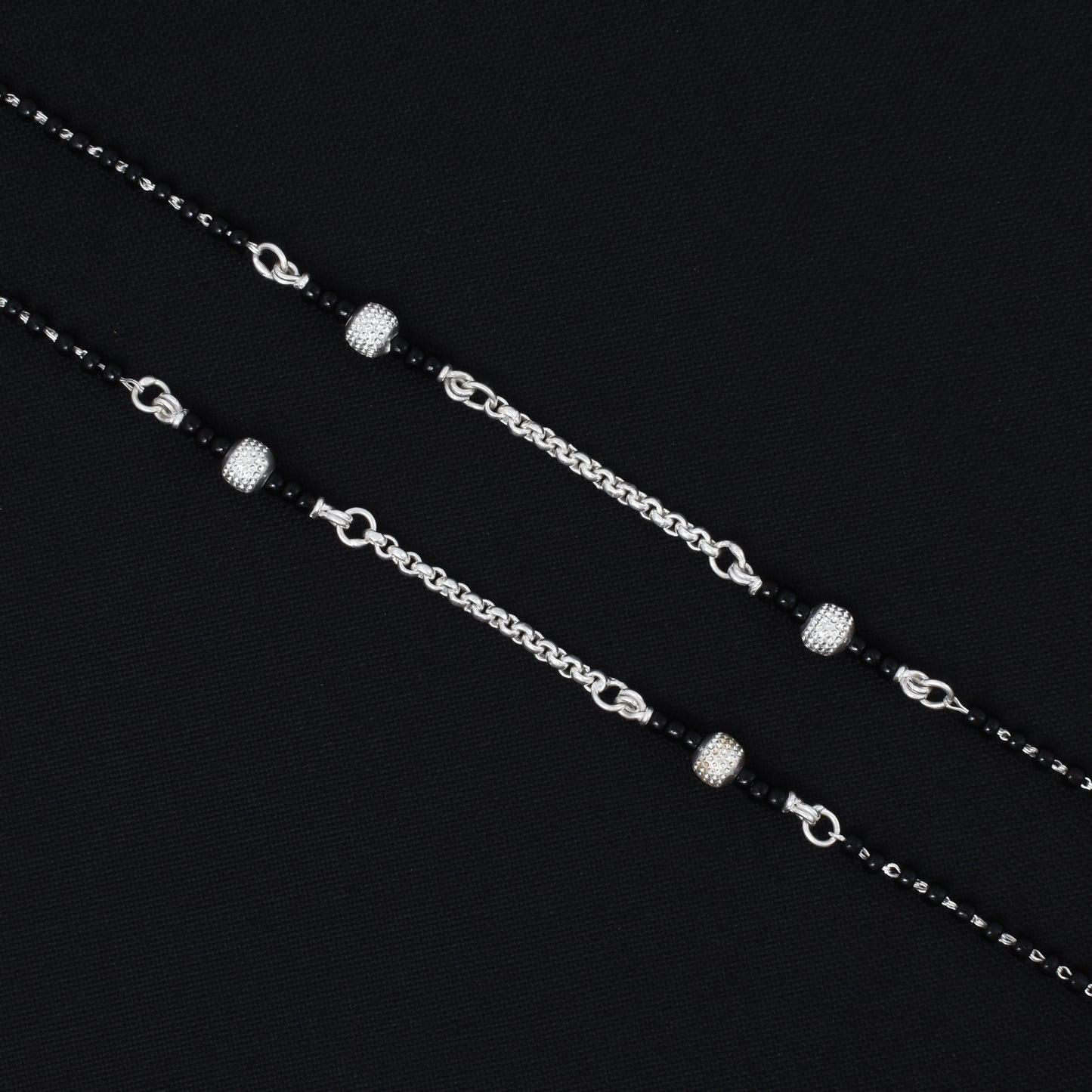 Silver payal with a sleek design and fashionable black beads, ideal for adding a bold accent to your style.