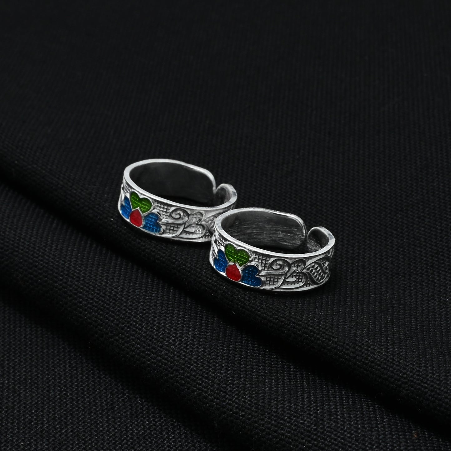 Handcrafted silver toe rings featuring sparkling, multi-colored flower designs, perfect for a fun and trendy appearance