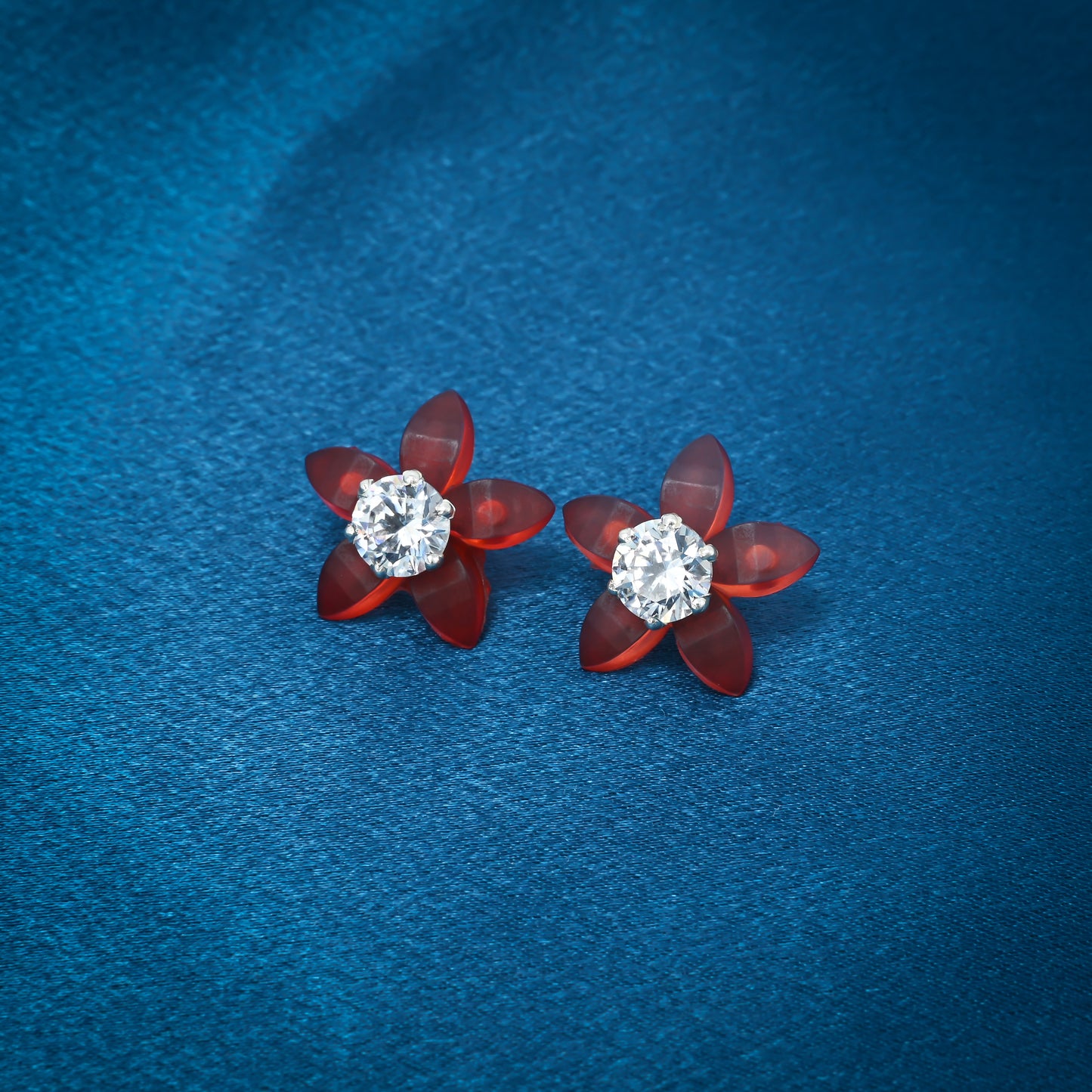 Silver flower earrings with vibrant orange petals and an American diamond center