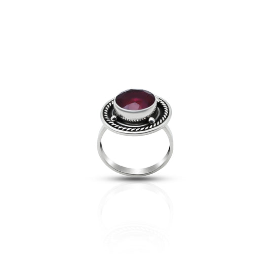Elegant silver ring featuring maroon round gem.