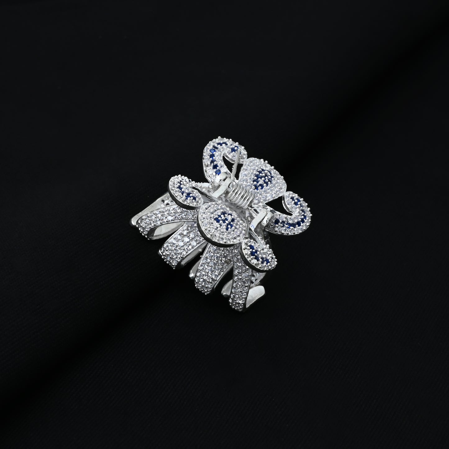 Stylish girls' silver clutcher adorned with blue and CZ gemstones
