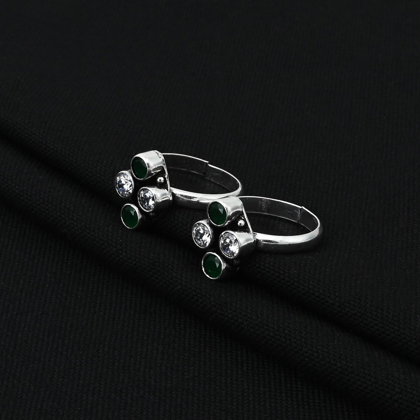 Handcrafted silver toe ring featuring white and green gems, ideal for adding a pop of color to your style