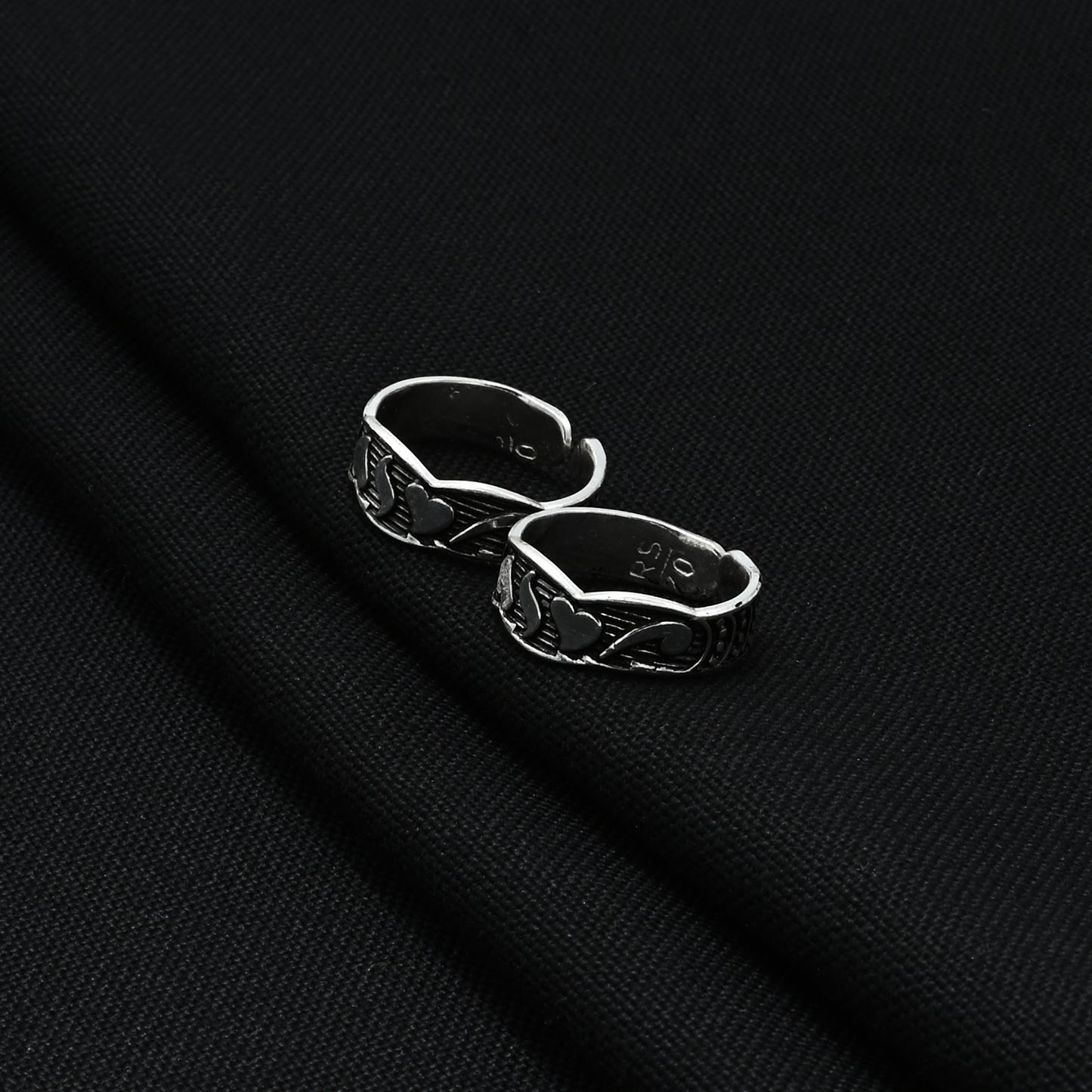 Handcrafted silver toe rings featuring a twisting heart design, perfect for a modern and loving appearance