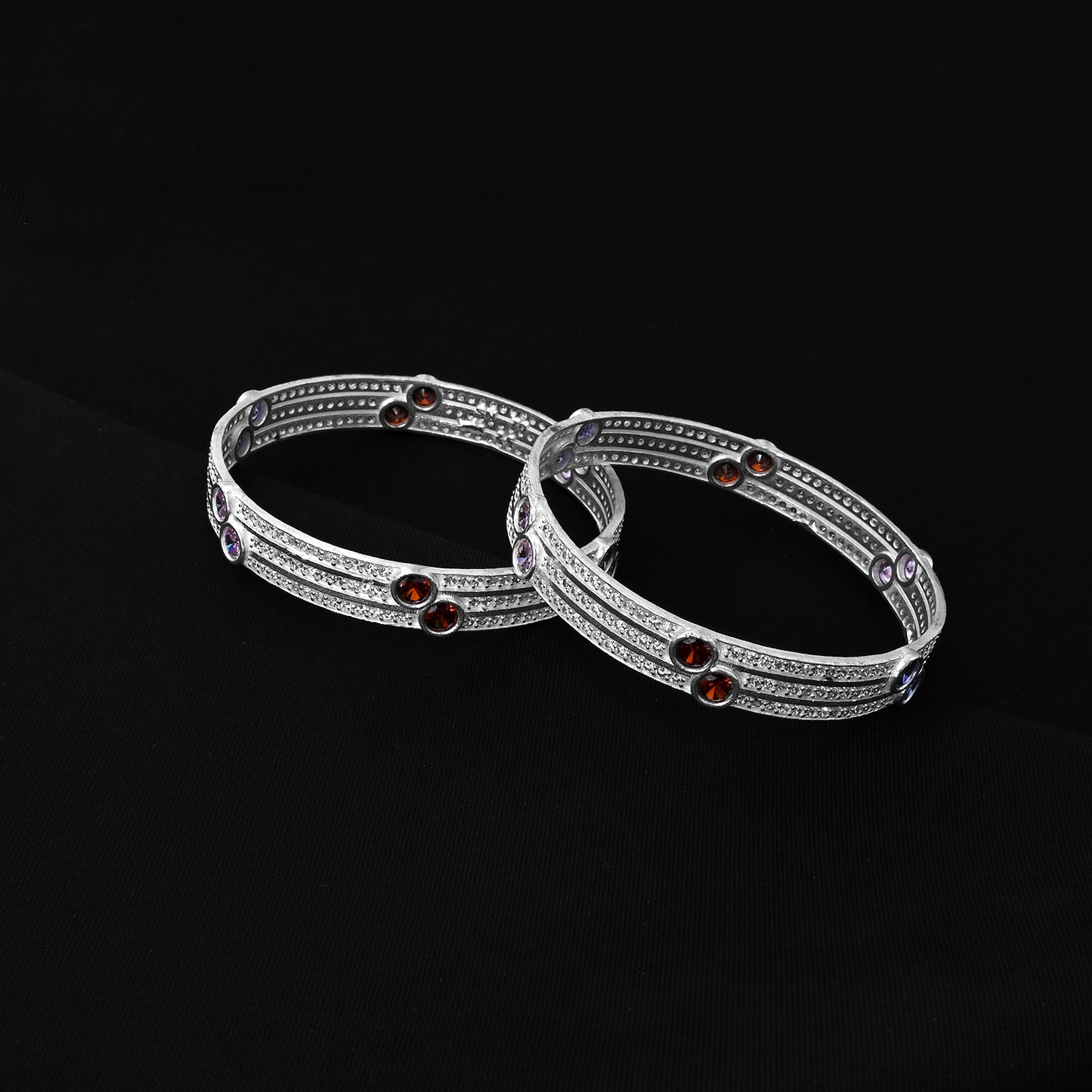 Silver bangles highlighted by bright, dazzling multicolor stones, ideal for adding a pop of color and sparkle to your look