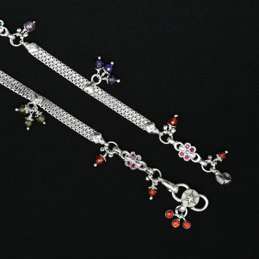 Elegant silver payal featuring shiny, fancy beads in a variety of colors.