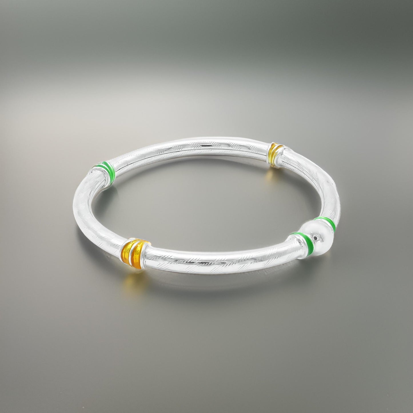 Sterling Silver Kada Featuring Simple Green and Yellow Lining Design