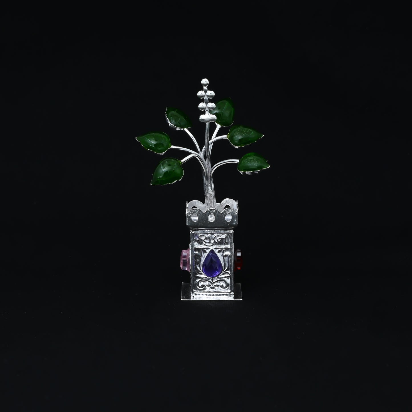 Handcrafted silver Tulsi plant with a lotus design and gemstone, ideal for religious practices