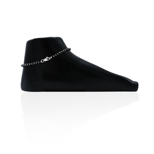 Charming silver anklet featuring black accents, ideal for a sleek and modern accessory