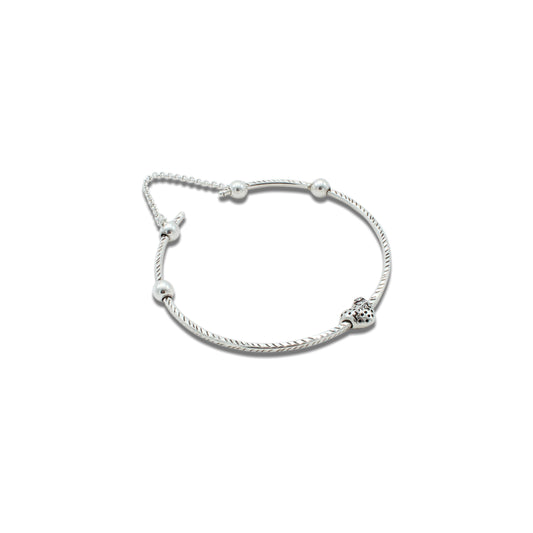 Elegant silver kada anklet featuring heart-shaped bead accents.