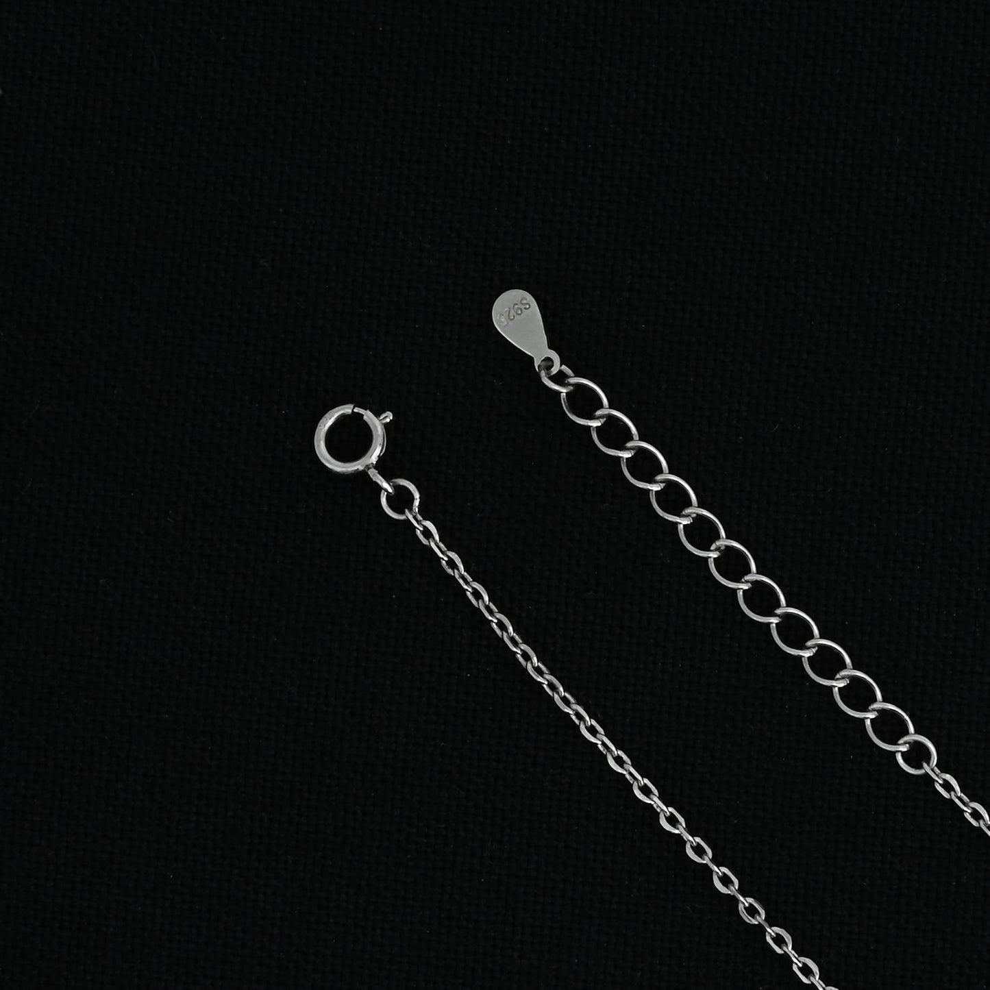 Elegant silver pendant necklace with personalized 'R' design.