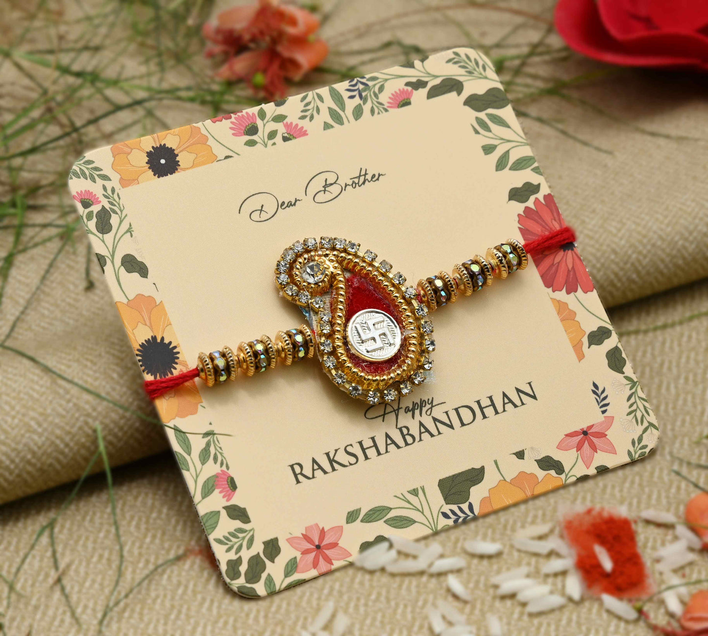 Silver center Swasthik design with a red theme and multiple colorful beads, perfect Rakhi for boys.