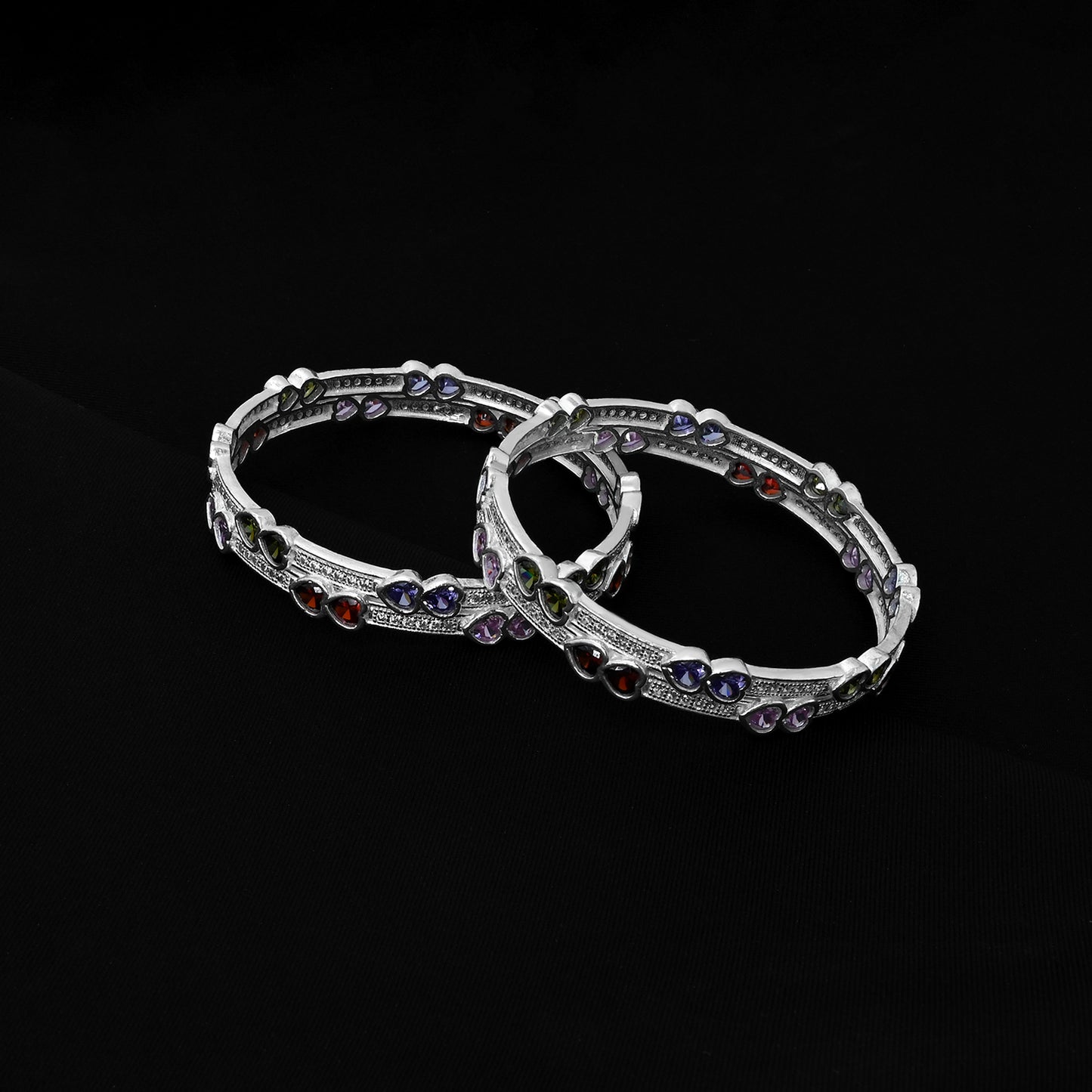 Stylish silver bangles with charming heart motifs, ideal for a meaningful and heartfelt addition to your jewelry collection.