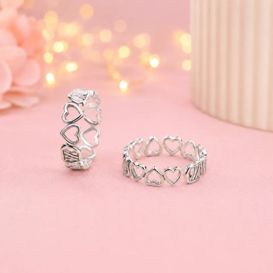 925 Sterling Silver adjustable heart design toe ring pair for women with open heart pattern displayed on a soft pink luxury background