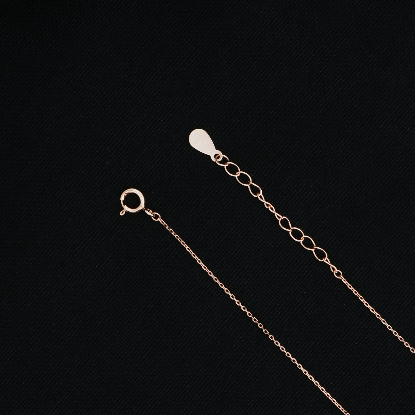 Rose gold heart pendant with a vibrant red center on a stylish chain