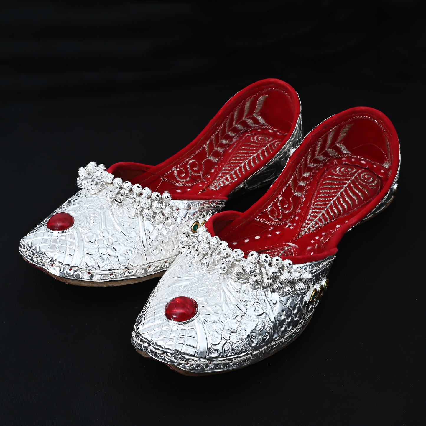 Elegant traditional jutti with flower design, red stone, and ghungroos