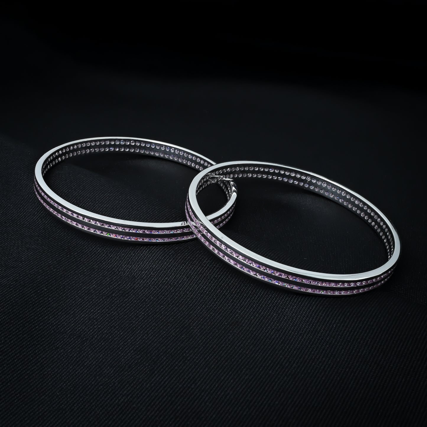 Charming silver bangles embellished with several light pink stones