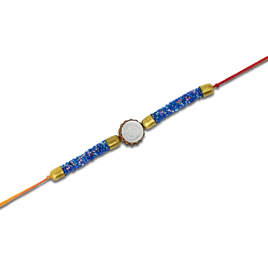 Boys' Rakhi featuring a silver Om centerpiece and blue flat circular plastic beads.