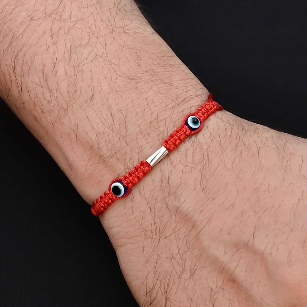 Elegant Rakhi with two purple evil eyes in silver, ideal for boys