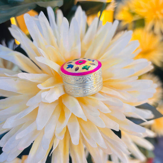 Elegant silver sindor box featuring a pink flower and vibrant multicolor leaves.