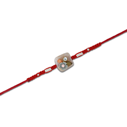 Boys' Rakhi featuring a silver grey flower with delicate leaf details.