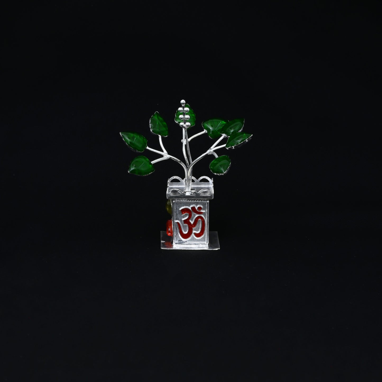 Handcrafted silver Tulsi plant with 'Om' written on it, ideal for enhancing worship rituals