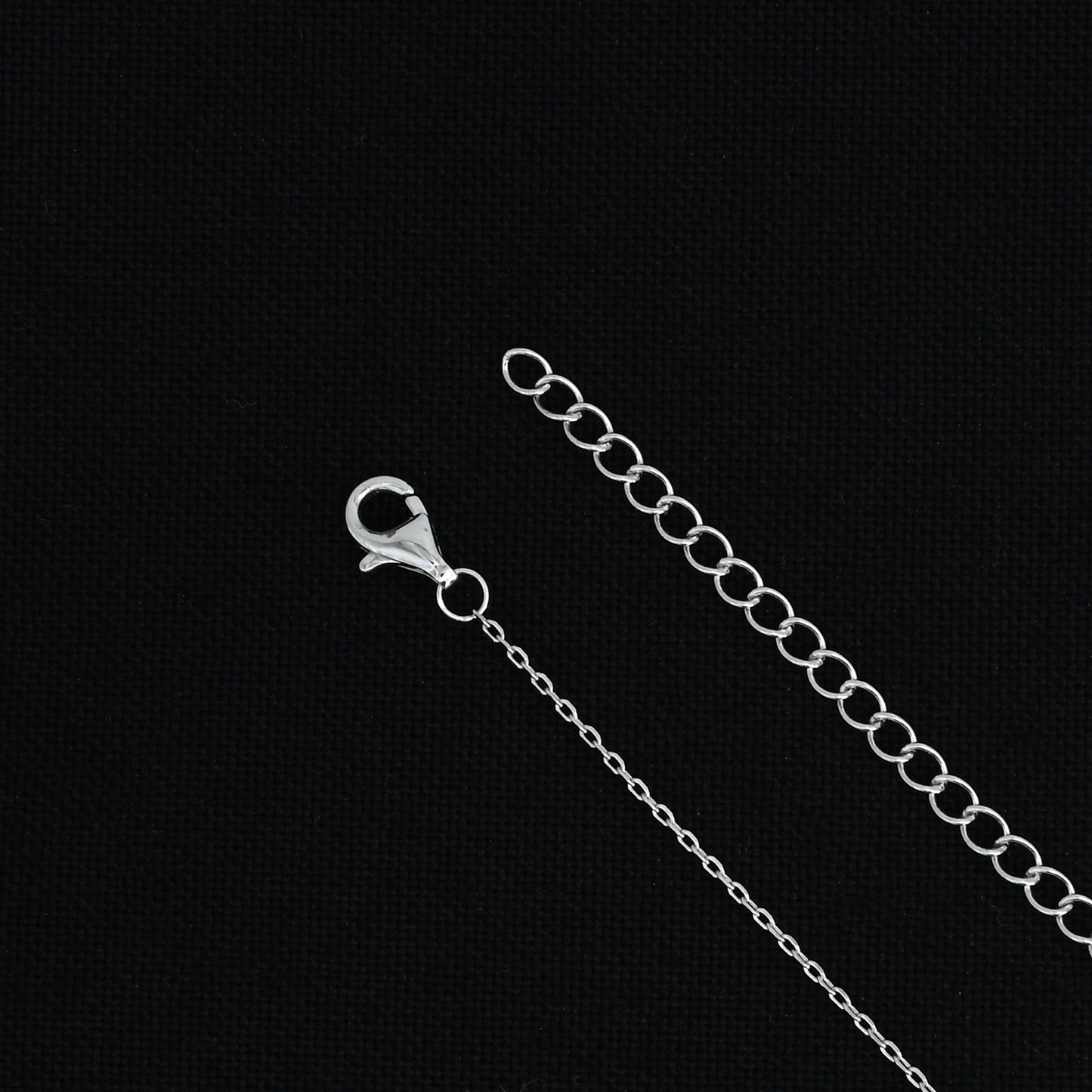 Elegant silver chain with striking power symbol pendant.