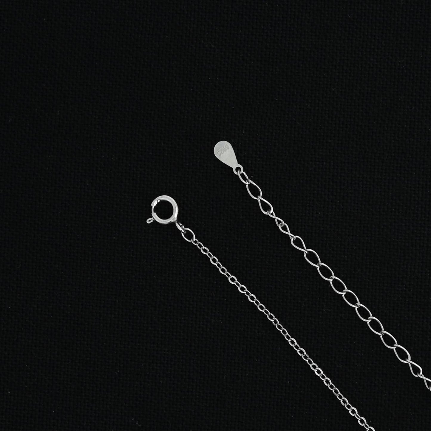 Silver chain with a custom 'E' symbol pendant.