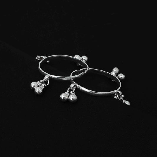 Charming silver baby kada adorned with ghungroos and a sleek plain design