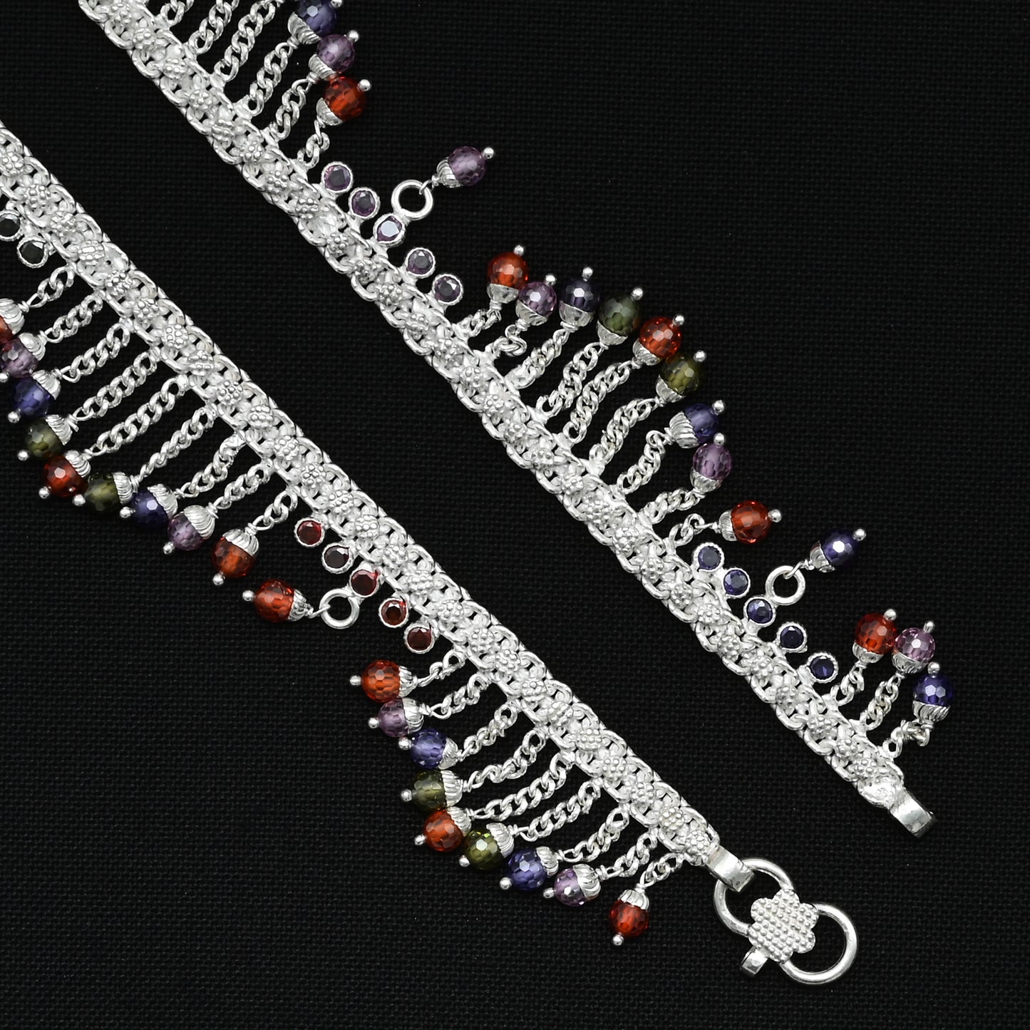 Silver anklet with a unique up-and-down colorful gem pattern, perfect for a lively and stylish look.