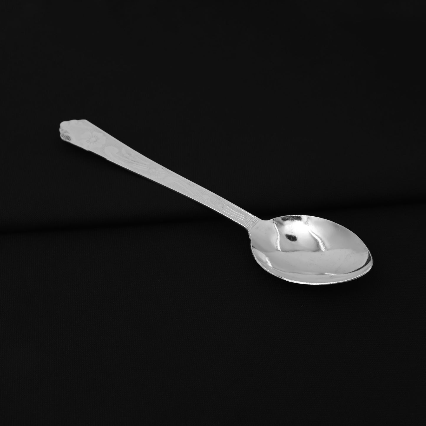 Decorative silver spoon featuring a floral motif