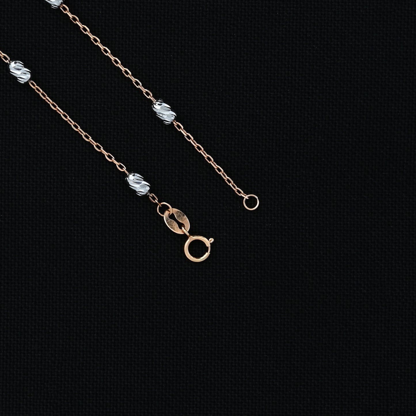 Elegant silver chain featuring rose gold links and stylish beads