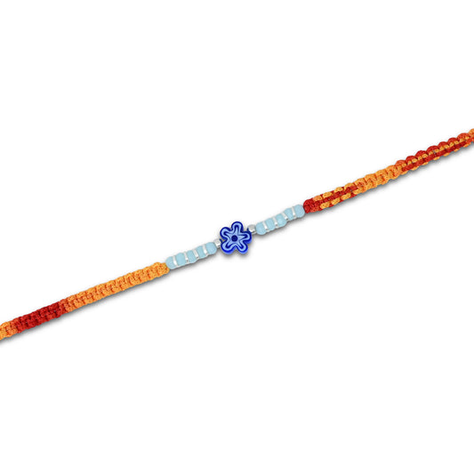 Boys' Rakhi featuring a silver blue flower centerpiece with silver and light blue beads.
