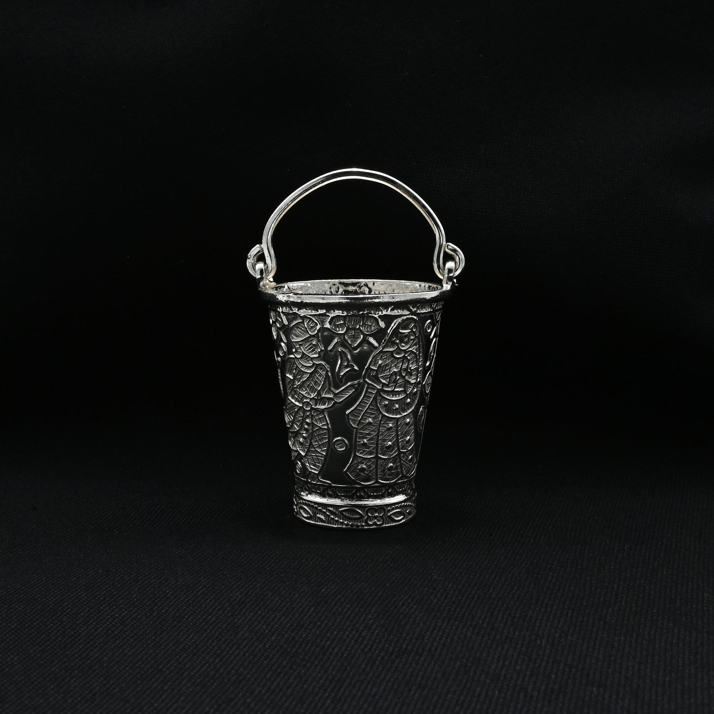 Traditional silver bucket adorned with a beautiful flower motif