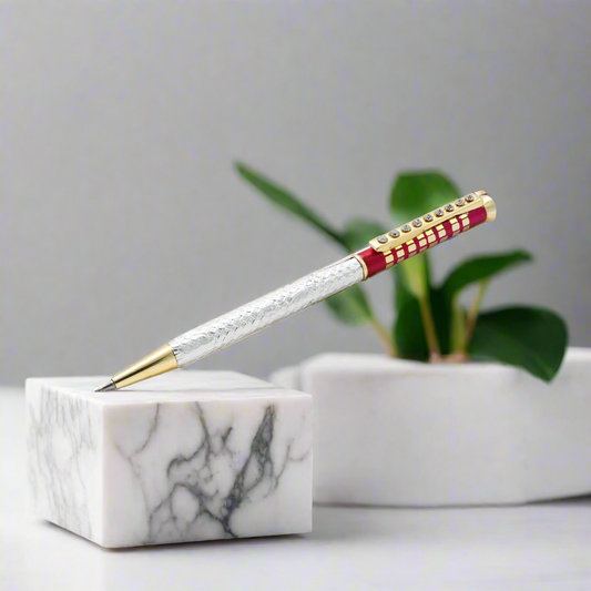 Silver pen with a red design and sparkling white gemstones