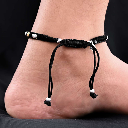 Silver payal featuring golden beaded evil eye.