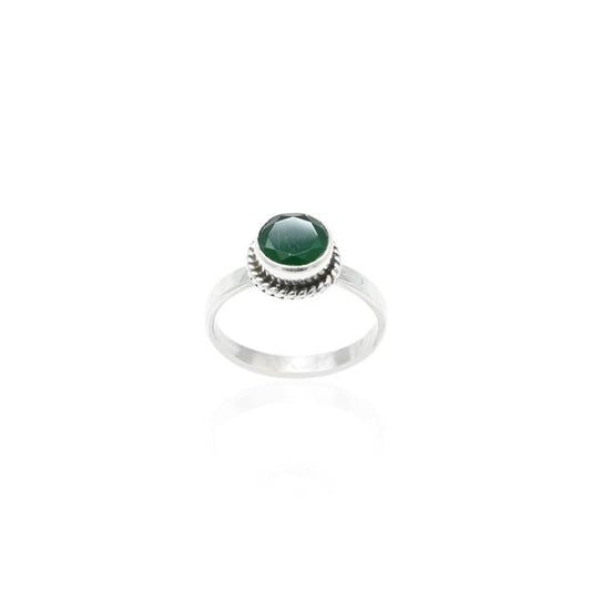 Close-up of a silver ring with a stunning round green gemstone, designed for a chic and elegant look.