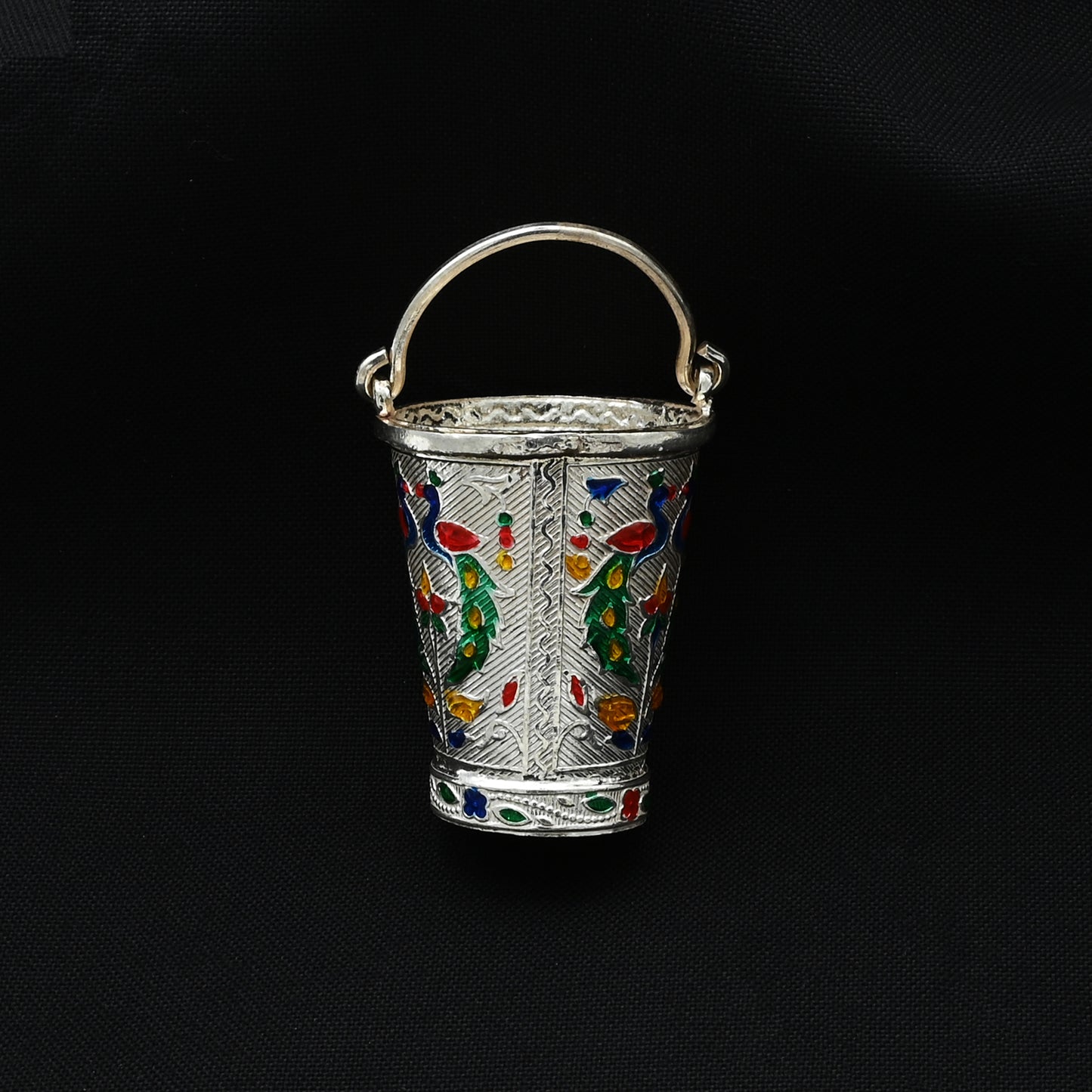 Traditional silver bucket featuring an intricate peacock motif