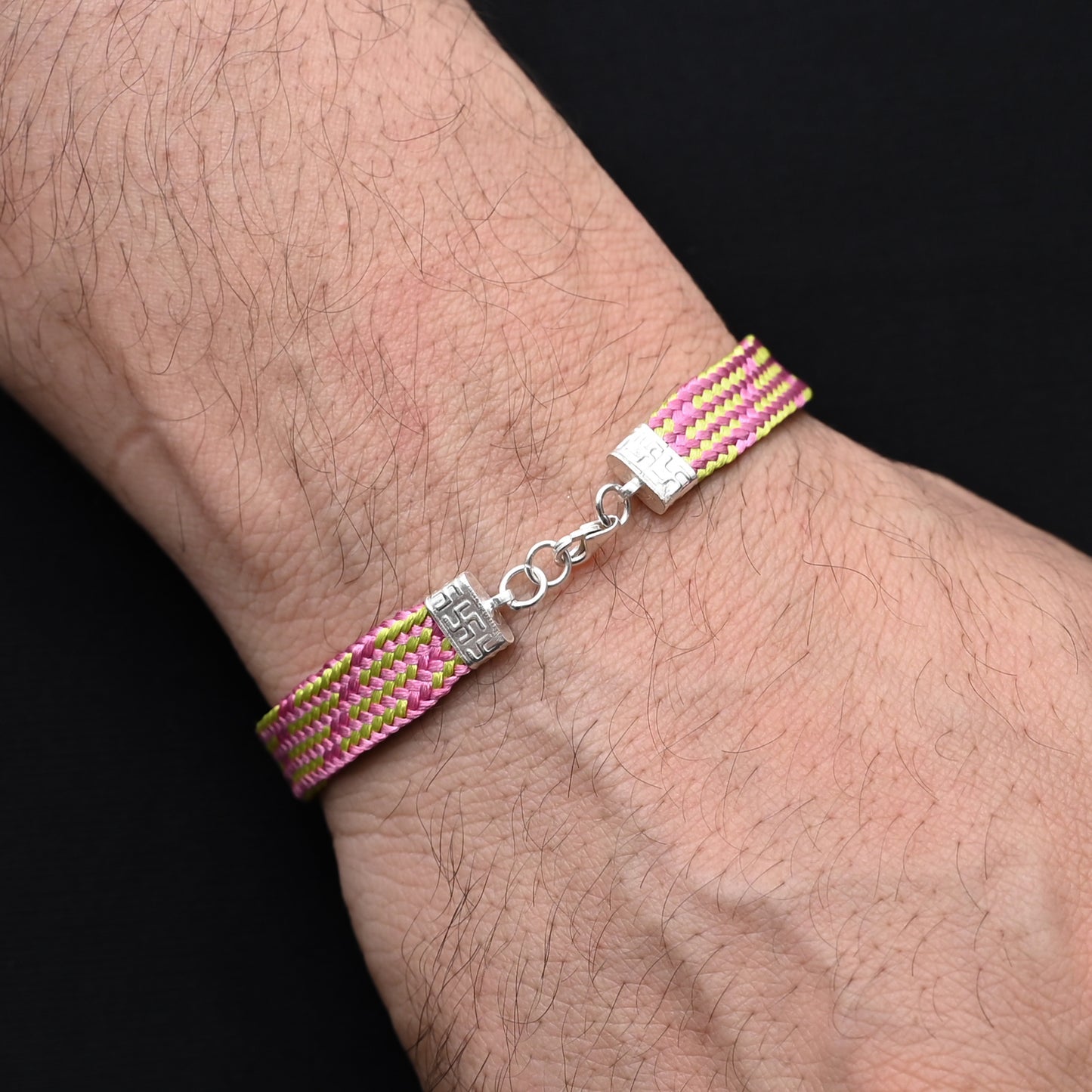 Timeless silver moli bracelet adorned with vibrant pink and green threads, perfect for casual wear