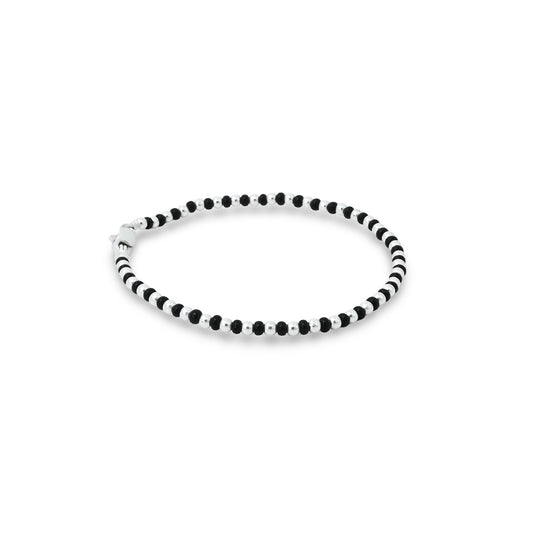 Elegant anklet made with a combination of black and silver beads, offering a sleek and fashionable accessory for girls