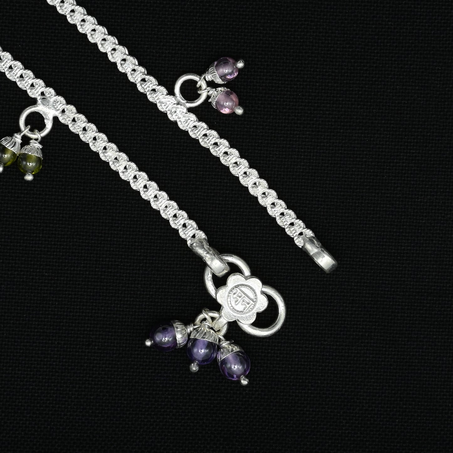 Silver anklet with a stunning arrangement of colorful gems, perfect for a playful and eye-catching style.