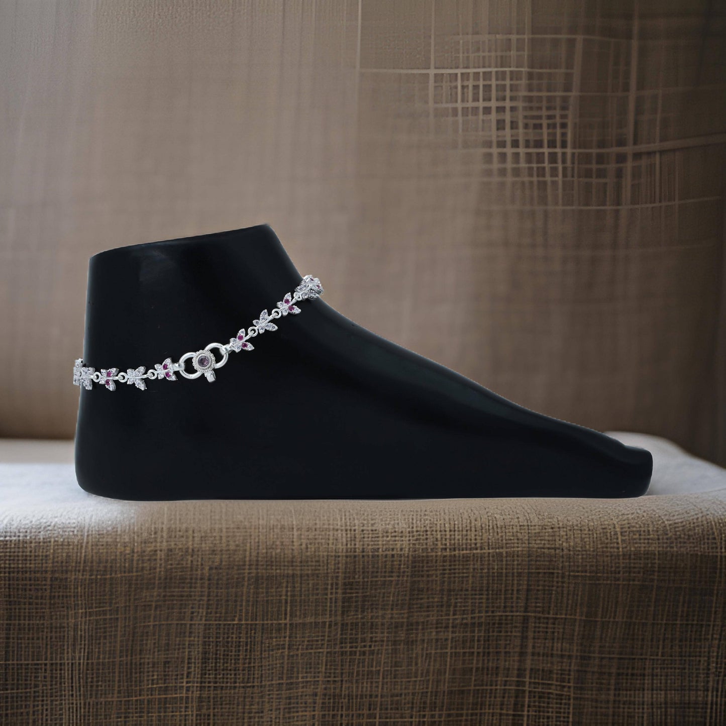 "Elegant silver anklet adorned with a beautiful pink gemstone butterfly motif for a playful touch