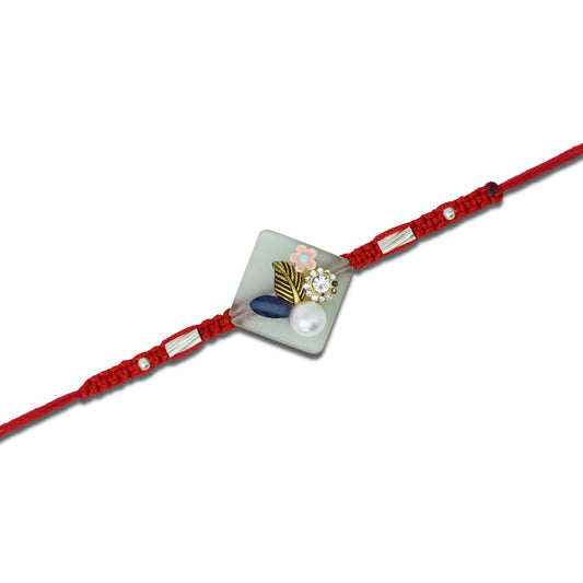 Boys' Rakhi featuring a silver flower design with pearl accents.